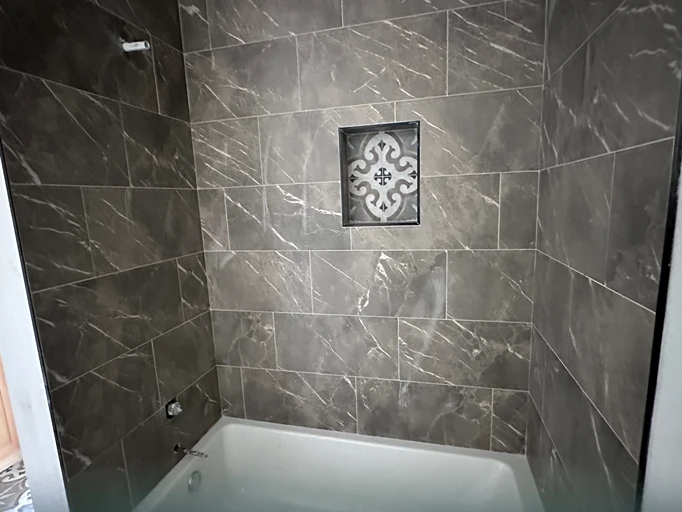 Mocha tiled shower with marbling 